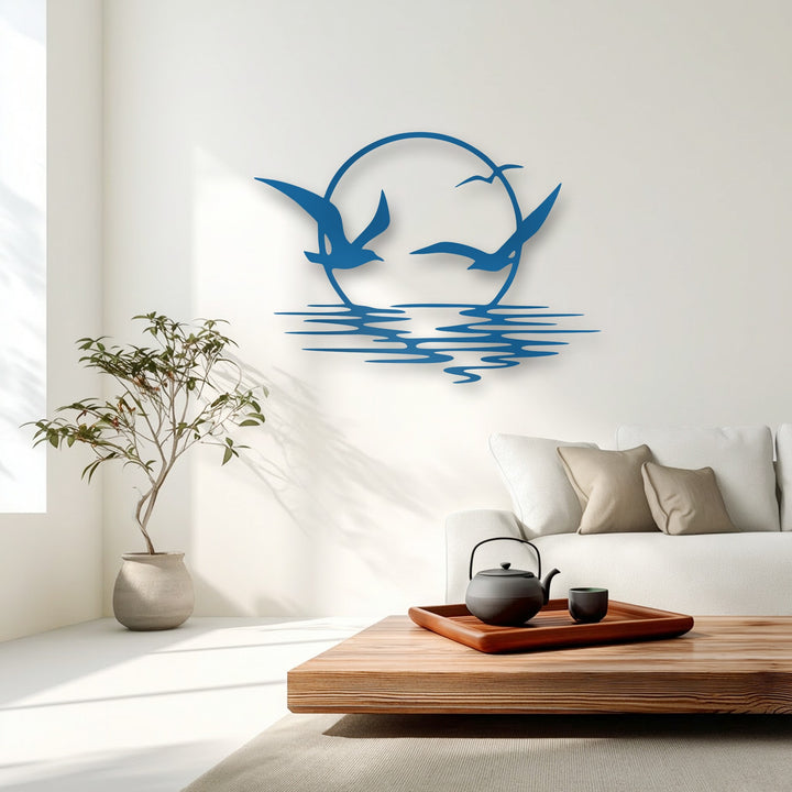 Soft, diffused sunlight gently illuminates the unique metal wall art, where soaring seagulls create a captivating coastal ocean sunset display.