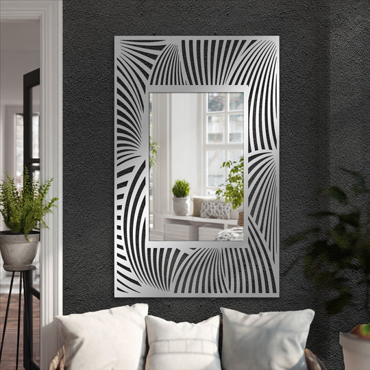 Organic, stylized forms create a dynamic, flowing wave pattern around this rectangular mirror, a bold example of decorating with wall mirrors.