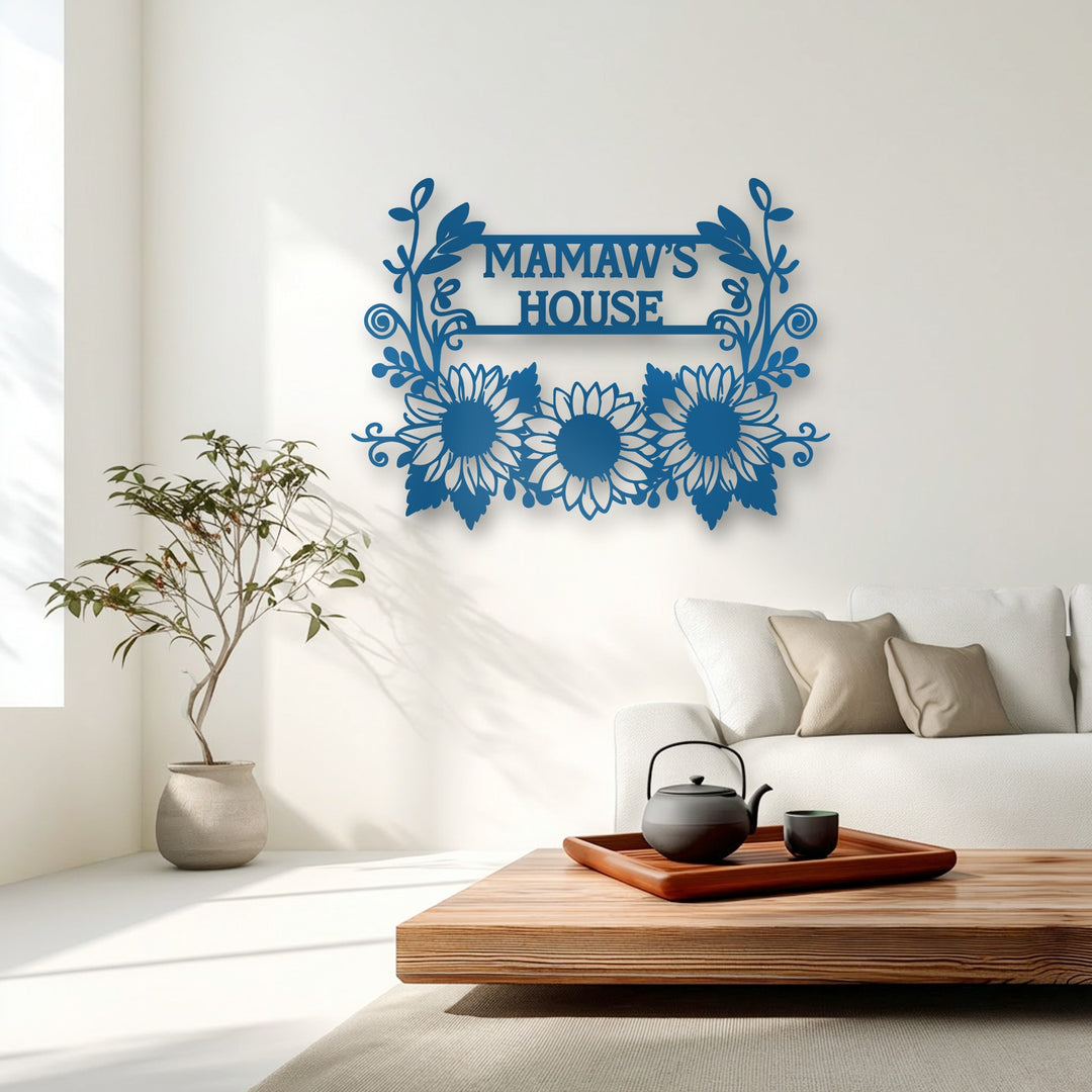 The matte blue finish of the personalized sunflower decoration wall art features an intricate laser-cut 'Mamaw's House' design.