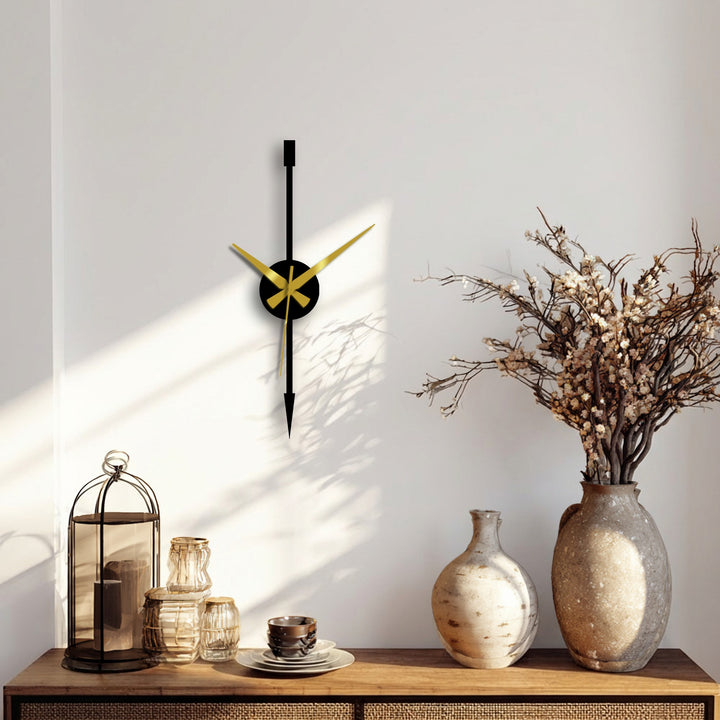 Highlighting its distinctive design, the minimalist vertical arrow metal wall clock is a captivating focal point and an example of decorative wall art with elegant gold hands.