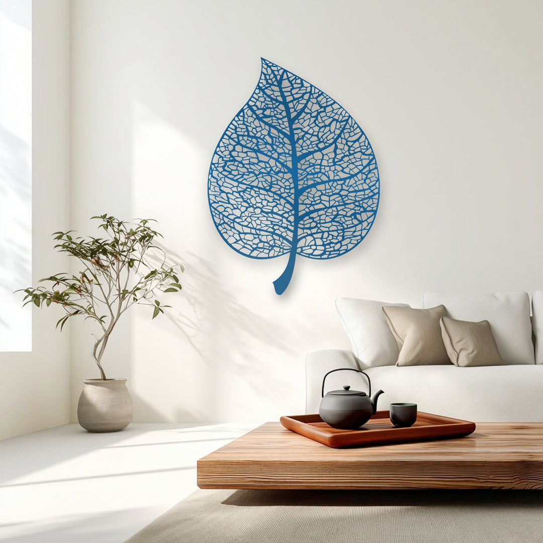 The transition between sunlit white walls and soft, shadowed areas is beautifully complemented by a vibrant blue intricate metal art for wall.