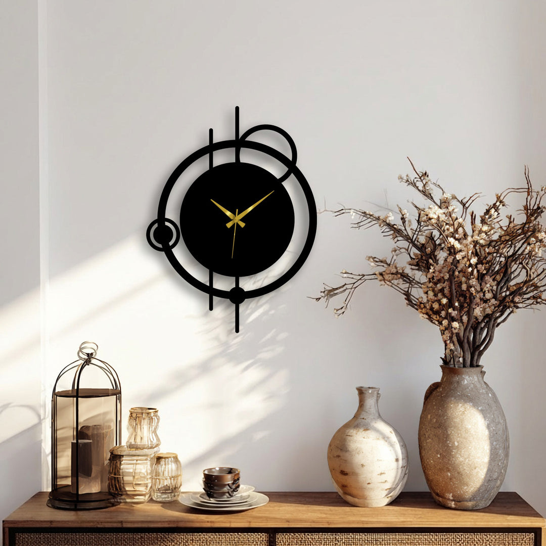 Shadows emphasize the unique metal wall art of this modern abstract orbit metal wall clock, highlighting the contrasting darkness of the clock face against the lighter wall.
