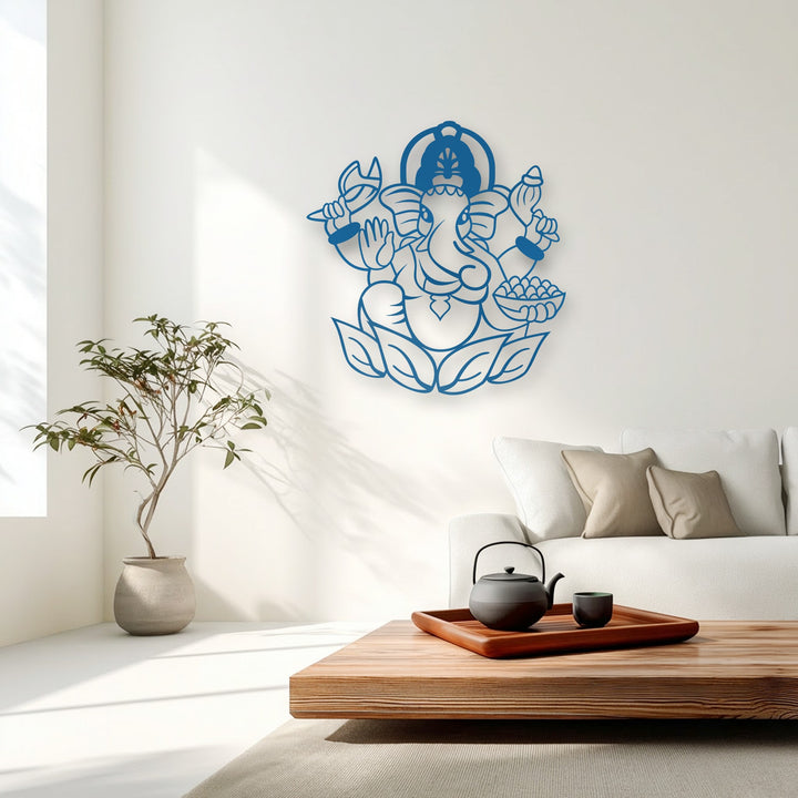 The vibrant blue of the sacred Ganesha decorative metal art sharply contrasts against the pristine white wall, creating a striking visual transition.