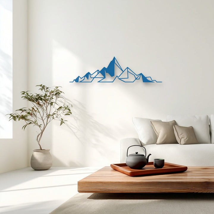 Negative space cleverly defines the azure geometric mountain metal art for wall, creating a striking minimalist scene against the bright white wall.