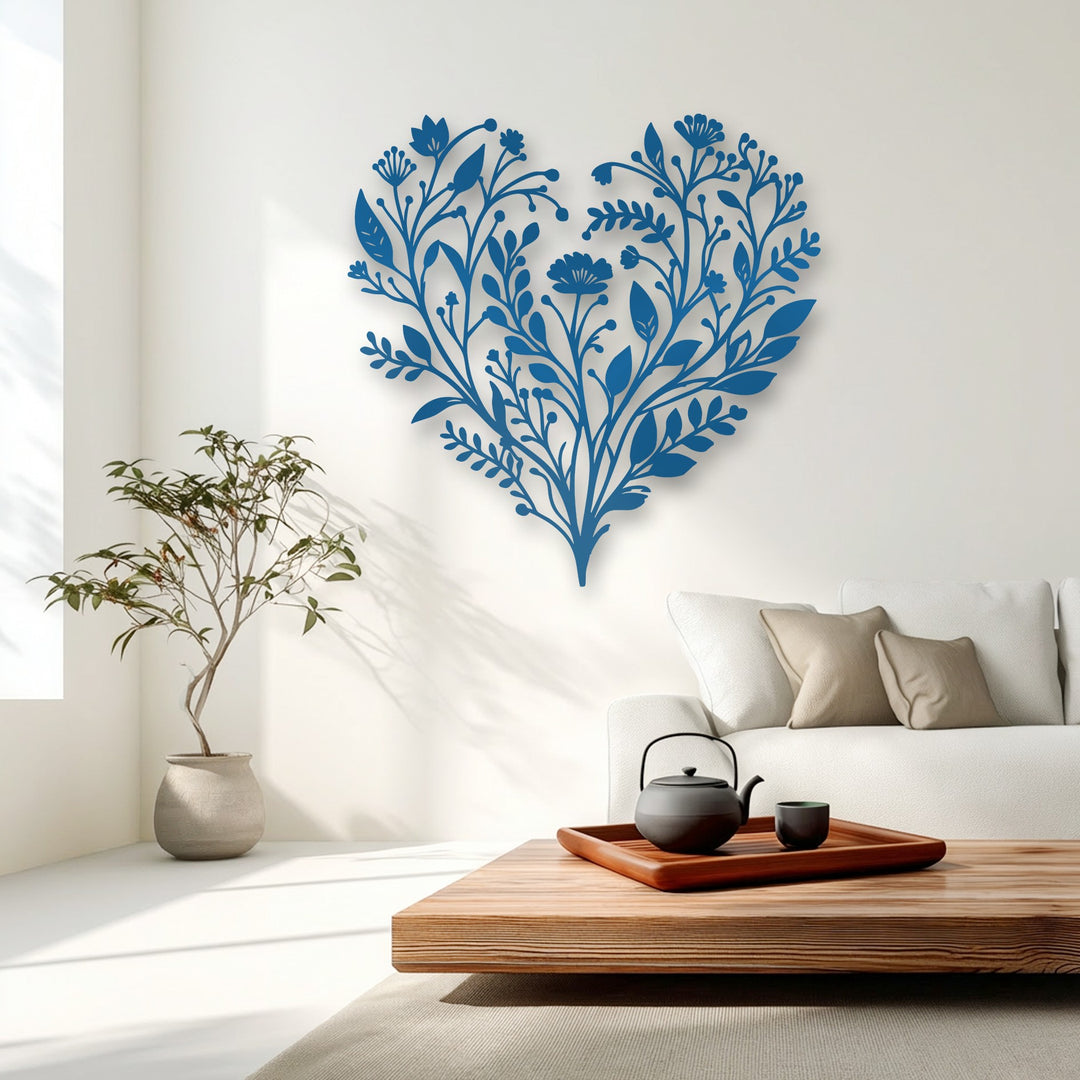 The vibrant blue botanical heart decorative metal art dramatically contrasts against the pristine white wall in this elegant room.
