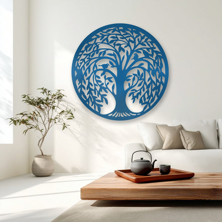The smooth, matte surface of the Tree of Life metal wall decor beautifully contrasts with the soft textile sofa and the polished wooden table.