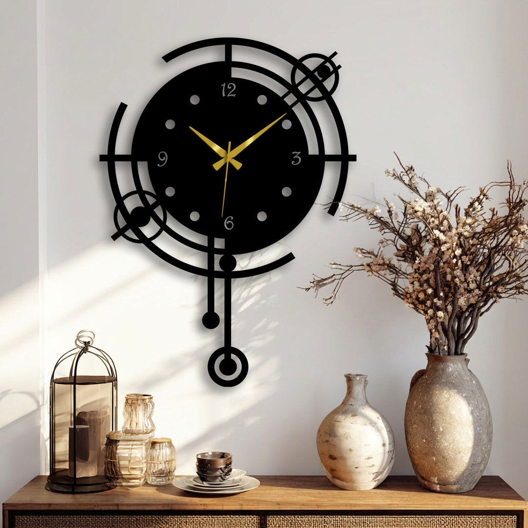 Warm lighting enhances the modern Orbit geometric metal wall clock, a bold black decorative metal art piece with golden hands, contrasting with the cool wall.