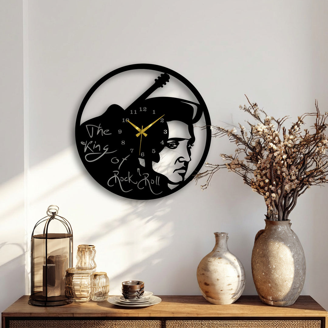Subtle light and dramatic shadows highlight the intricate Elvis Presley rock music icon decorative metal art wall clock with guitar design.