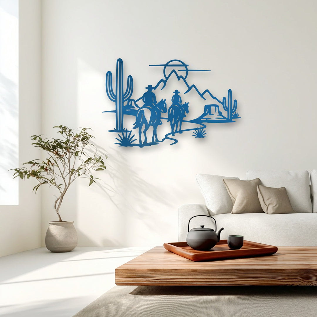An expansive azure unique metal wall art piece depicts cowboy silhouettes riding horses through a rugged desert with cacti and mountains.