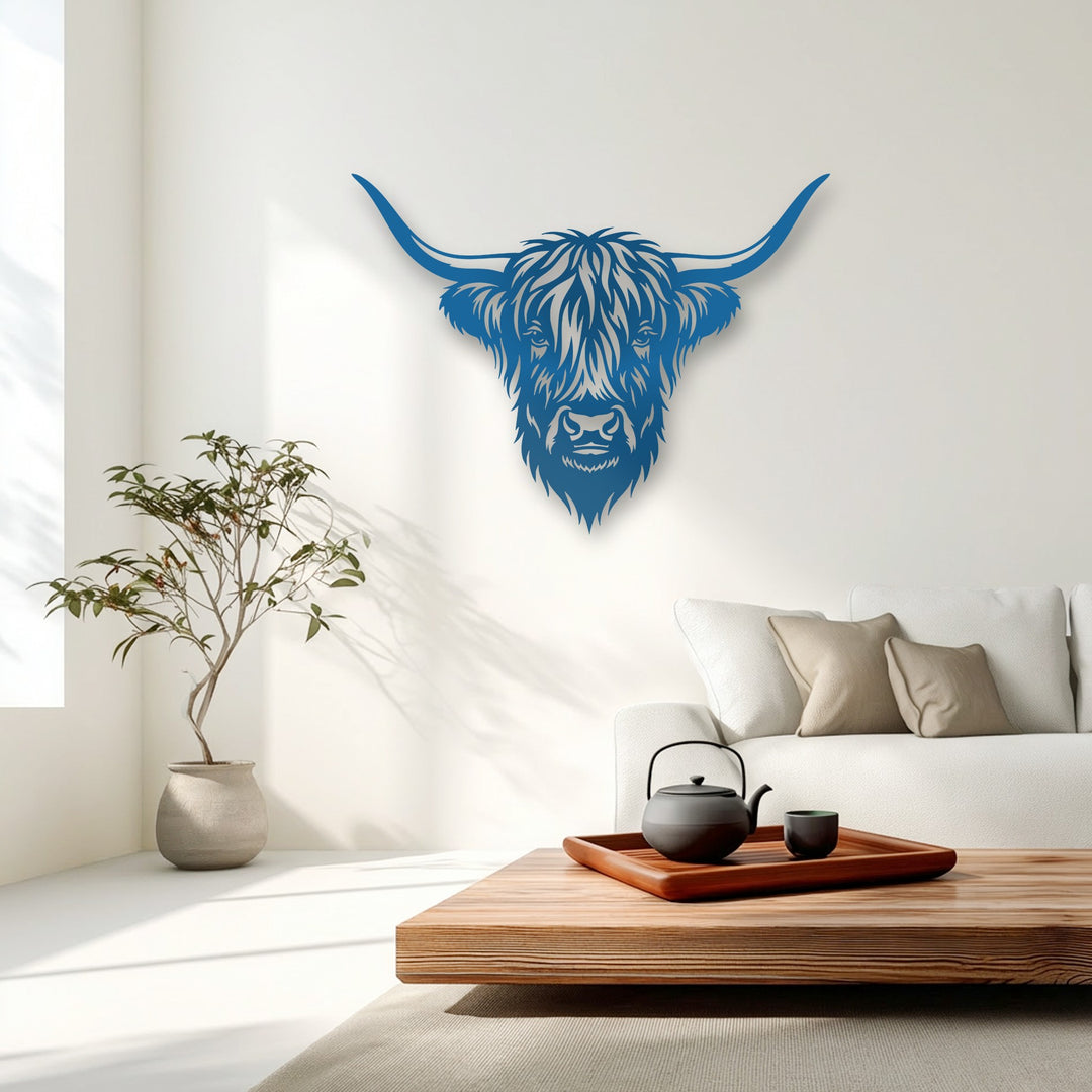 Angular lines and stylized geometric contours define the vibrant blue decorative metal art of a Majestic Highland Bull Head.