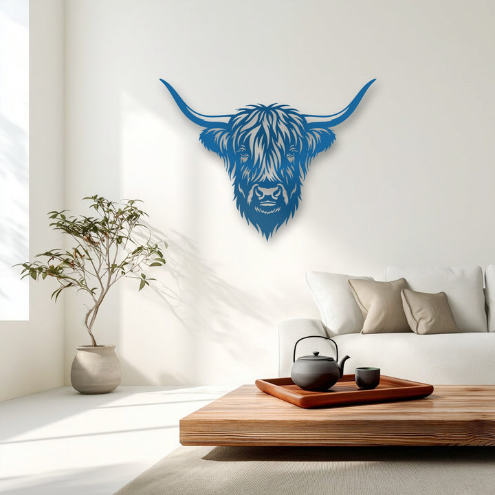 Angular lines and stylized geometric contours define the vibrant blue decorative metal art of a Majestic Highland Bull Head.
