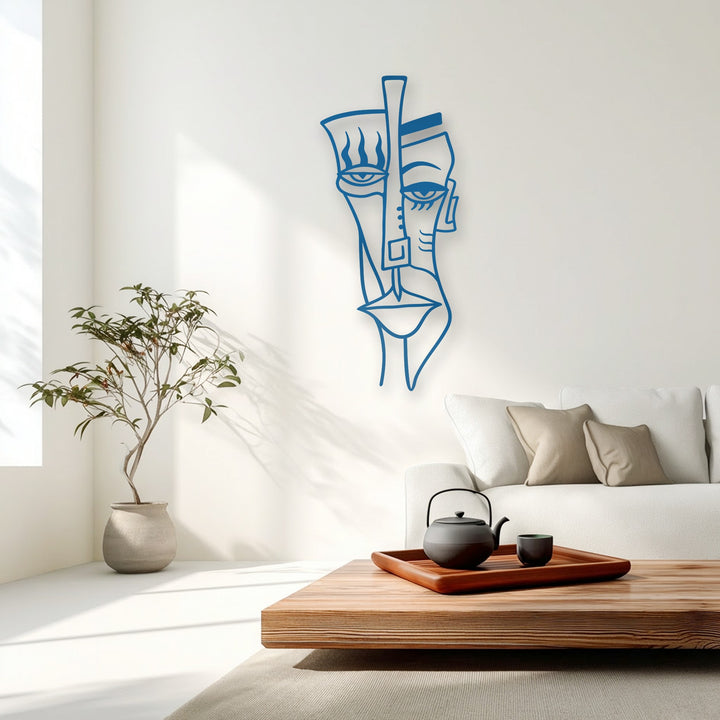 Warm sunlight and soft shadows accentuate the elegant blue abstract tribal face metal art for wall, complementing modern home decor.