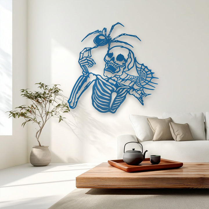 The cool color temperature accentuates the vibrant cobalt unique metal wall art featuring a Gothic skeleton and spider on a bright white wall.