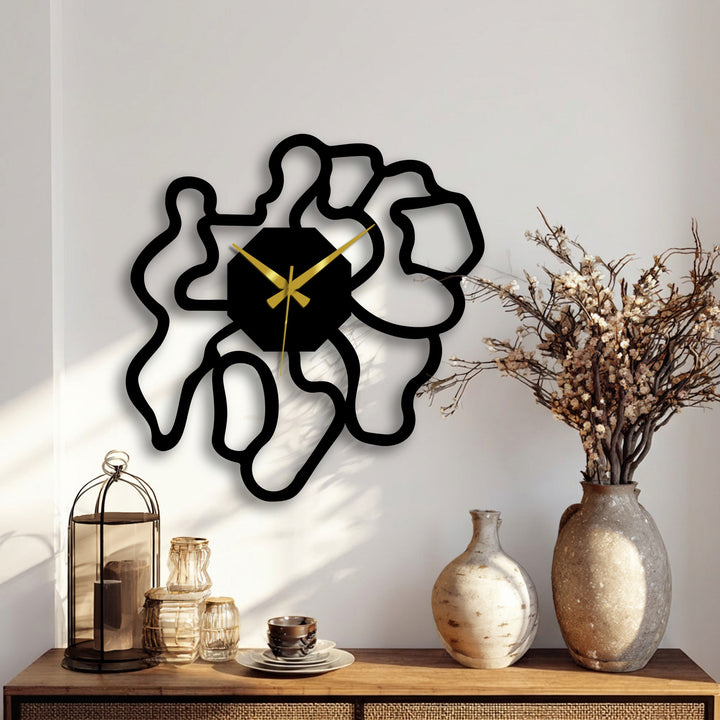 Negative space defines the design of this modern abstract metal artwork clock, creating a focal point with its organic shape and stylish silhouette.