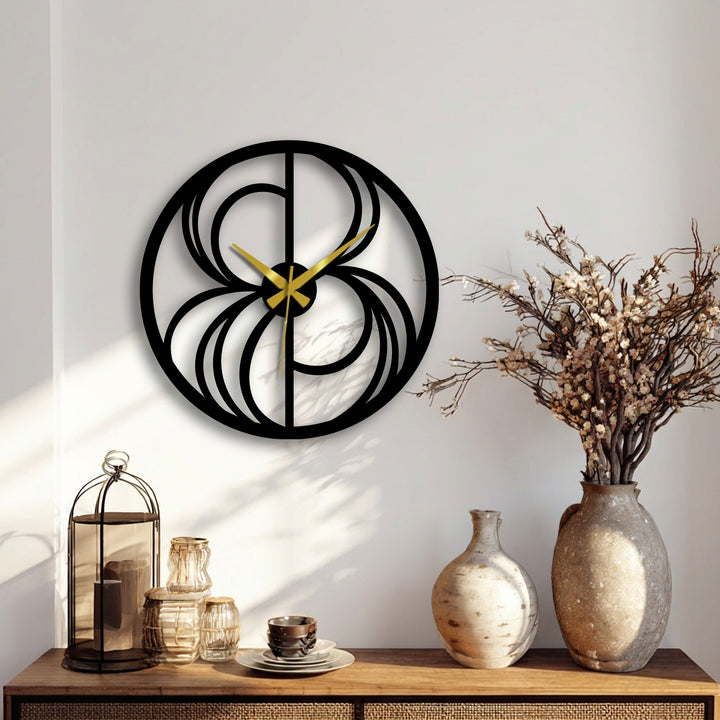 Highlighting the transition between golden clock hands and the black metal art for wall, this abstract swirl metal wall clock presents a striking, modern design.