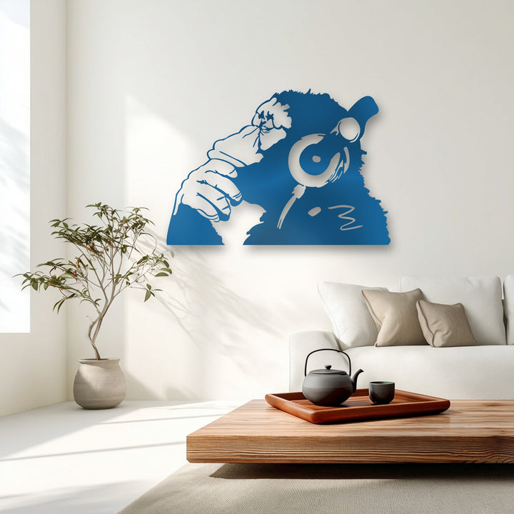 An abstract silhouette of a thoughtful monkey wearing headphones, crafted as vibrant azure blue metal art for wall decor.