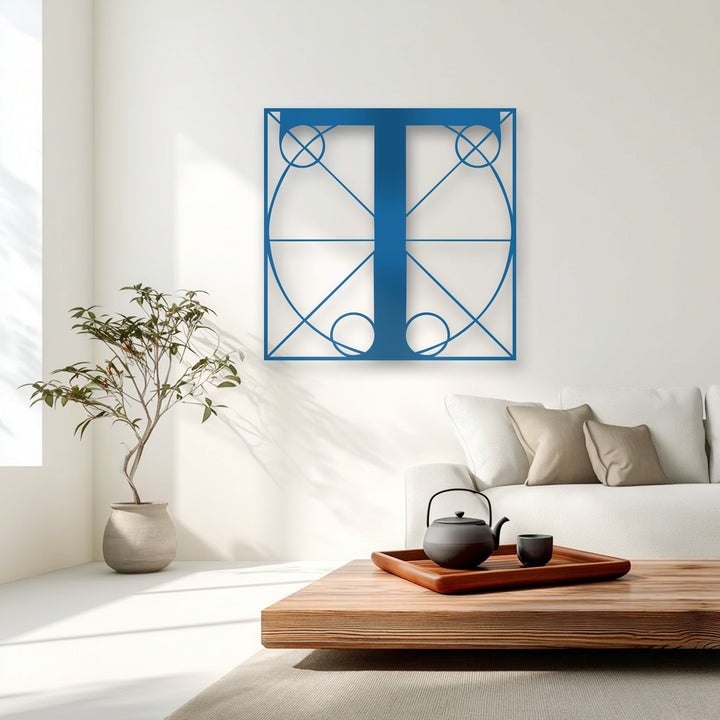 The crisp, cool color temperature highlights the striking sapphire geometric T decorative metal art against a bright white wall.