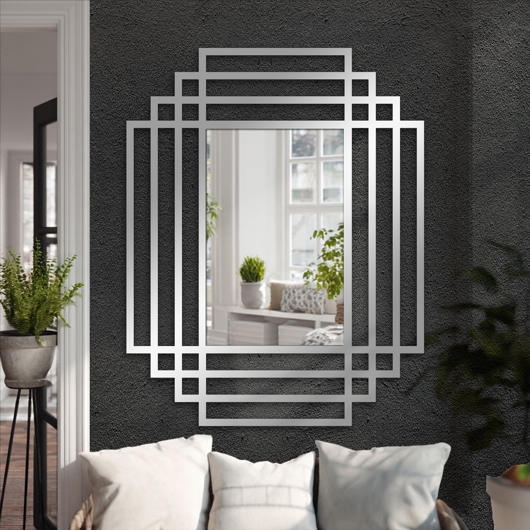 Reflected in the symmetry grid modern wall mirrors is a bright window view, contrasting with the dark wall behind the layered frame design.