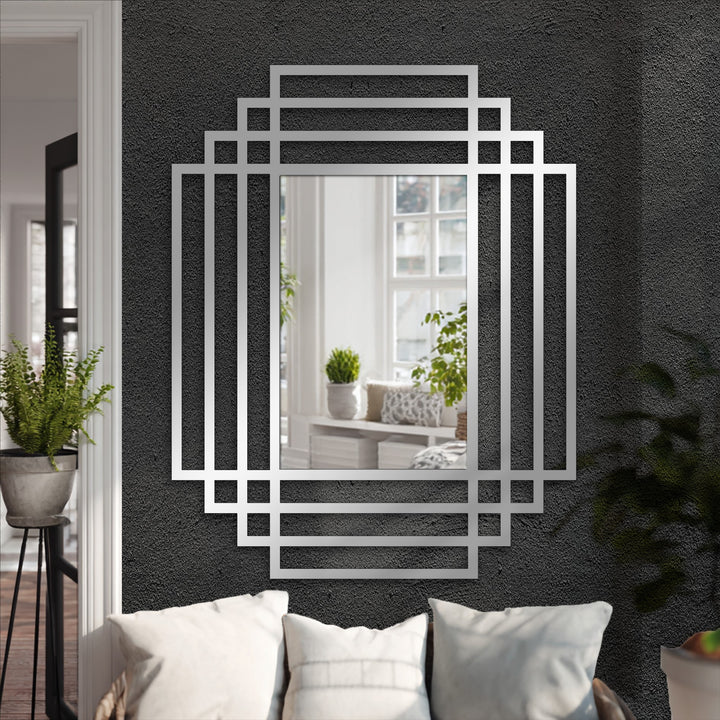 Reflected in the symmetry grid modern wall mirrors is a bright window view, contrasting with the dark wall behind the layered frame design.