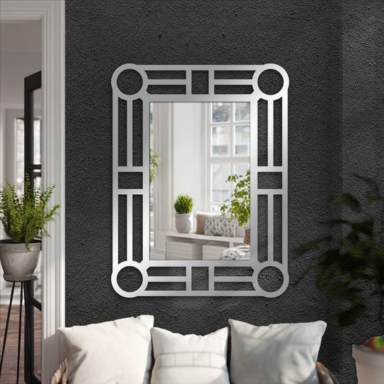 Featuring an artistic geometric design, the metal artwork’s decorative edge and patterned borders create a captivating framed wall mirror for a modern space.