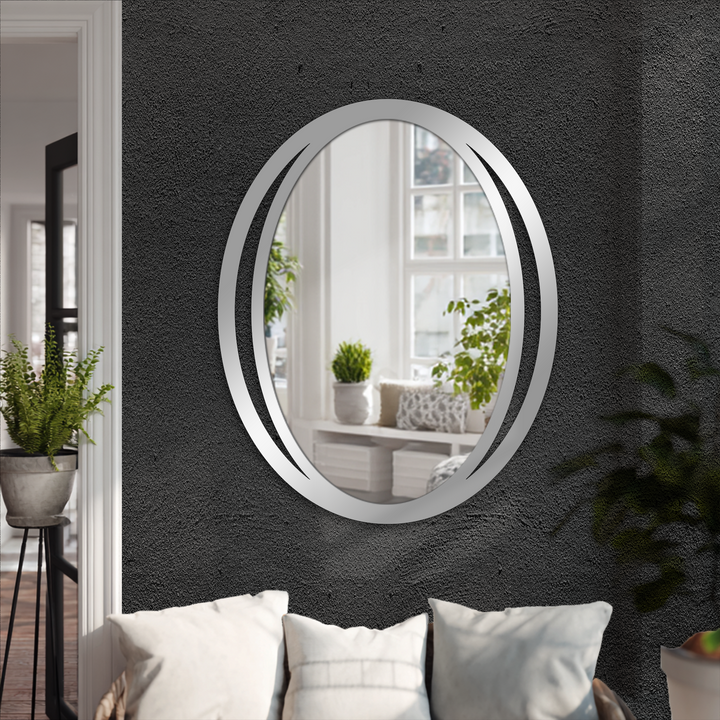 Gray decorative mirror with a sleek modern dual frame design reflects a bright interior, adding a minimalist touch to the dark, textured wall.