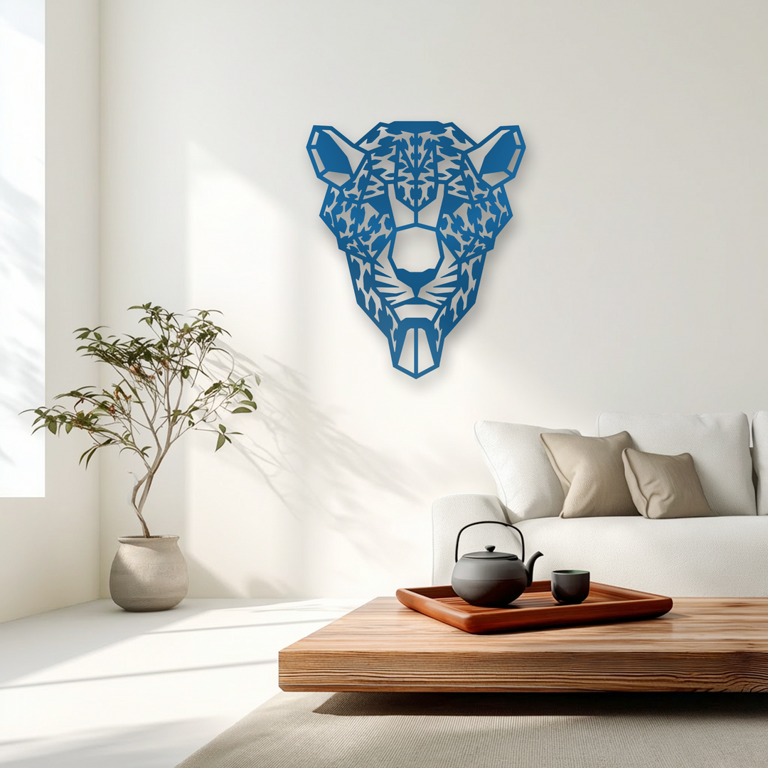 Intricate metal artwork in a geometric tiger head design showcases dynamic depth and layers against a bright wall.