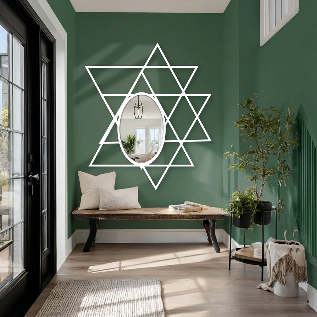 White finish defines the modern intersecting triangles forming a geometric oval floor mirror, providing an interesting reflective metal wall decor.