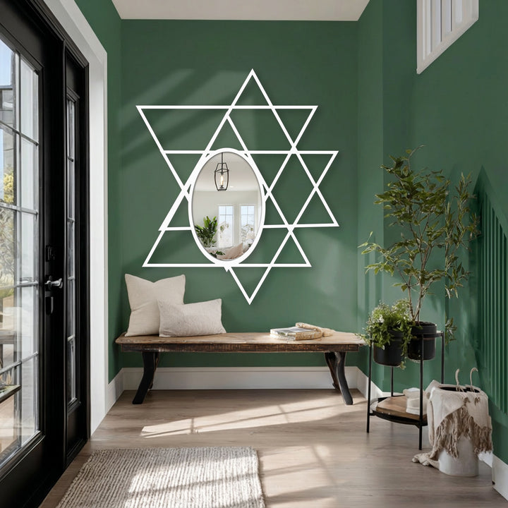 White finish defines the modern intersecting triangles forming a geometric oval floor mirror, providing an interesting reflective metal wall decor.