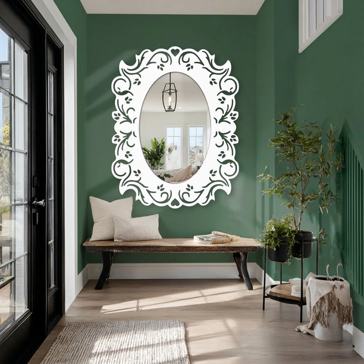 Reflected light shines from the bright center of the oval stained glass wall mirror framed with an ornate white floral design in a cozy entryway.