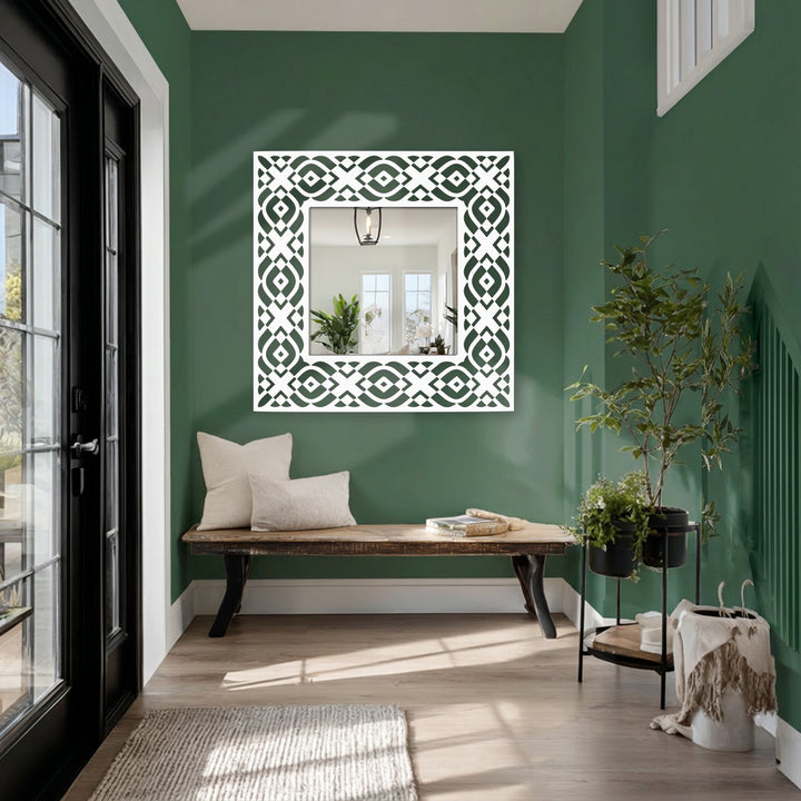 Against a deep green wall, the background accentuates the geometric tribal pattern frame of the square floor modern mirror, lending a stylish home decor touch.