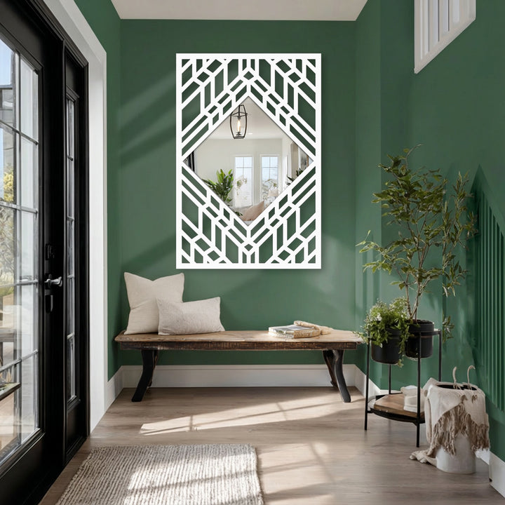 Against a deep green wall, this decorating with wall mirrors piece features a striking art deco geometric diamond floor mirror with layered line frame, reflecting the room's interior.
