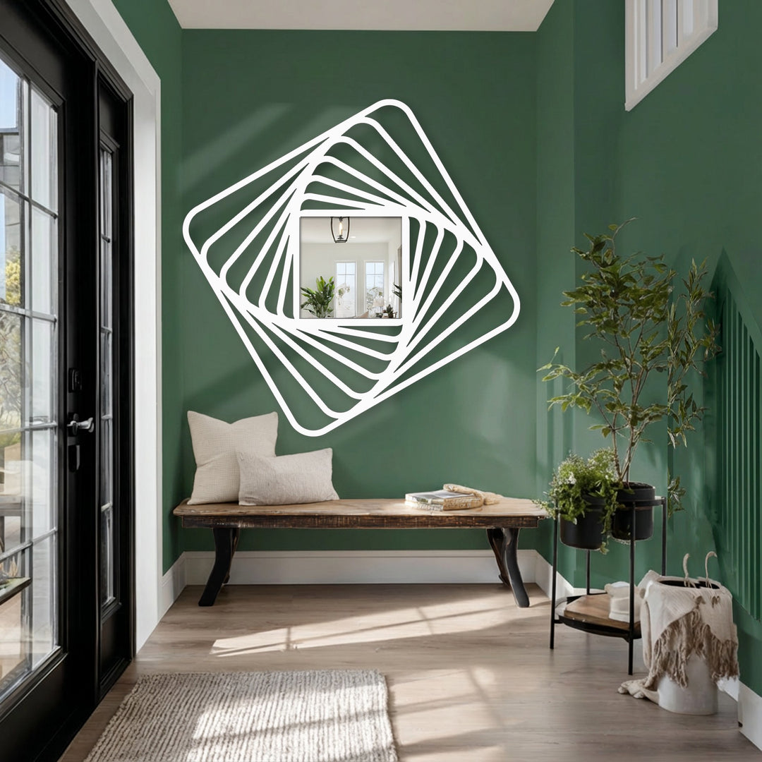 A deep green wall creates a striking backdrop for this dynamic framed wall mirror, enhancing the twisted square spiral design with its rich, earthy tones.