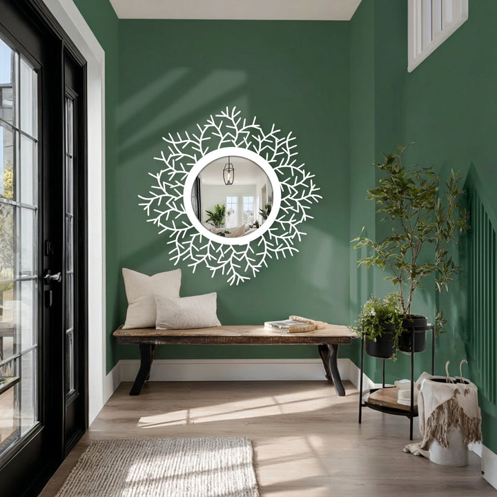 Foreground shows a botanical halo floor mirror, showcasing black metal leaves framing a round looking glass, a decoration wall art.