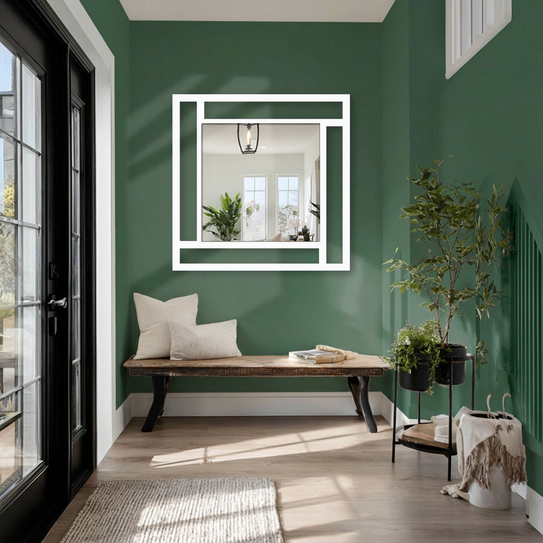 Light and shadow play across this modern metal wall mirror with its unique geometric frame, offering a reflective accent that enhances the space's depth with artistic metal art for wall.