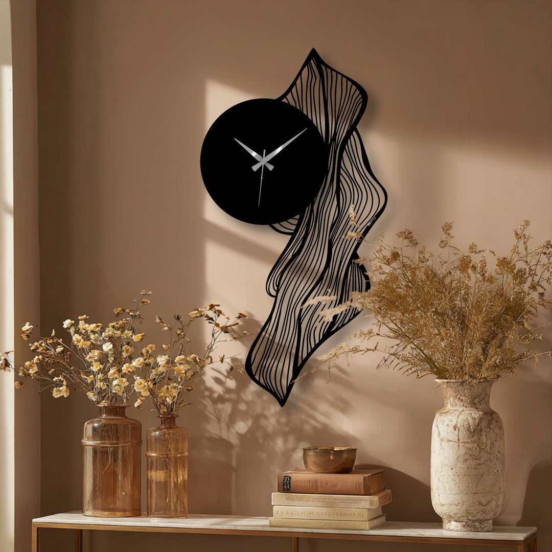 Delicate surface texture on the flowing abstract leaf metal artwork adds a modern, artistic flair to this decorative wall clock.