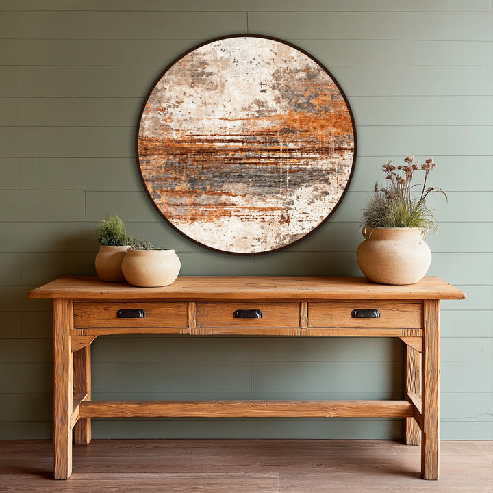 Negative space highlights the round Rust Horizon Texture, a piece of oil painting decoration, contrasted by the light green wall behind it.