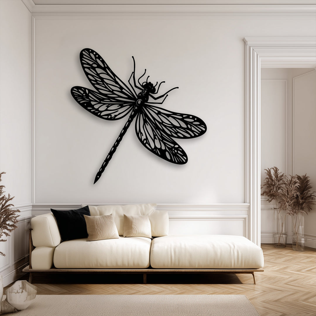 The elegant black dragonfly metal wall decor is the striking focal point, set against a pristine white wall above a plush beige sofa.