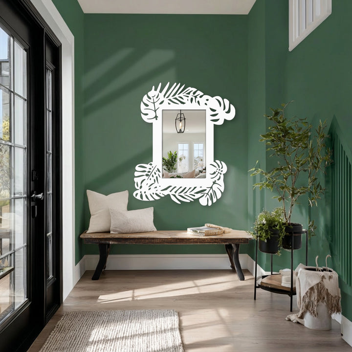 Vertically oriented, the tropical leaf frame decorative metal art mirror for wall decor features a botanical statement design with ornate cutouts.