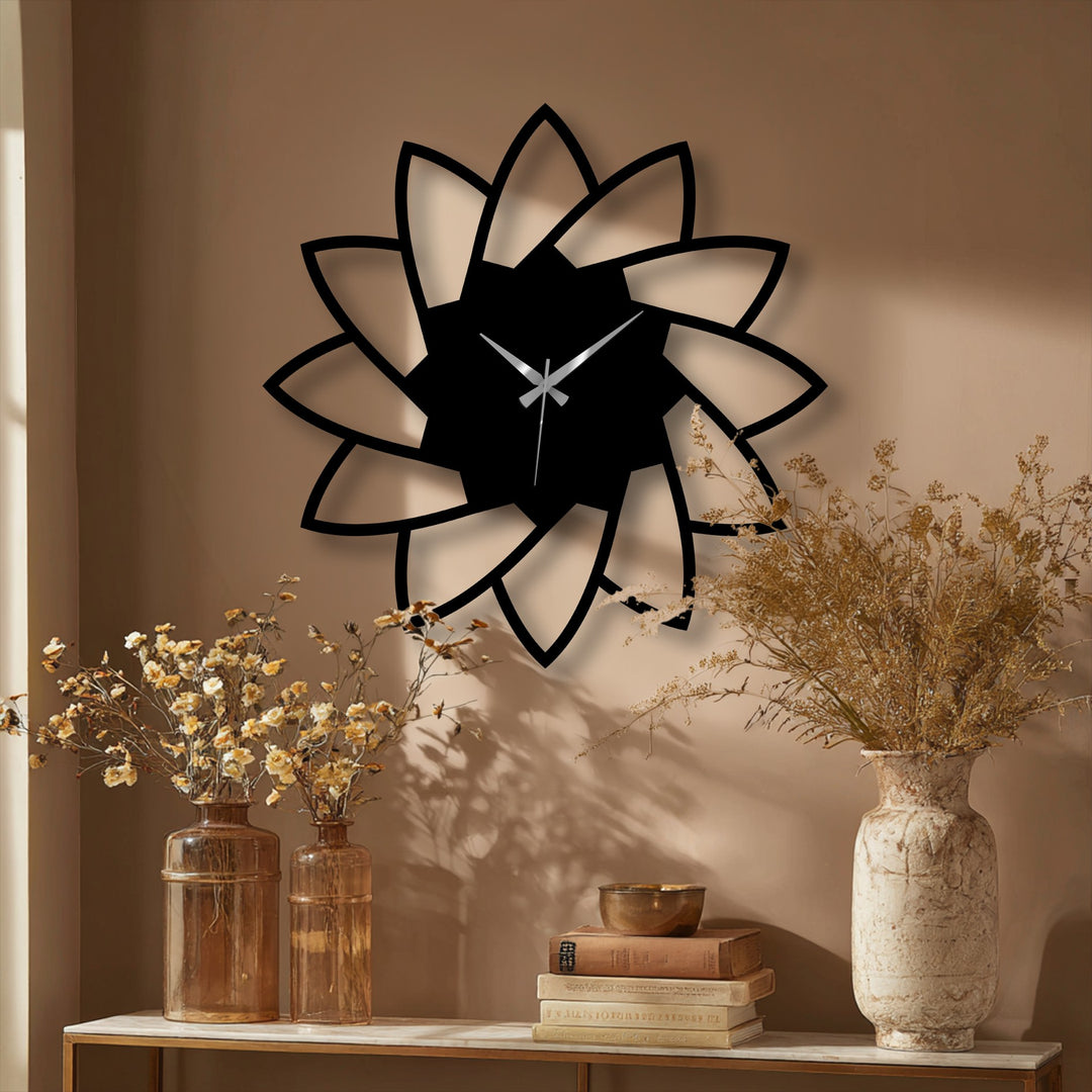 Black finish highlights the elegant lotus bloom metal artwork of this minimal floral design wall clock, creating a striking contrast against the neutral backdrop.