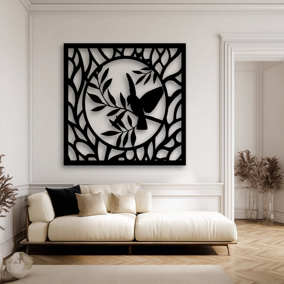 The elegant, white-walled room, adorned with classical moldings, perfectly showcases the striking metal wall decor.