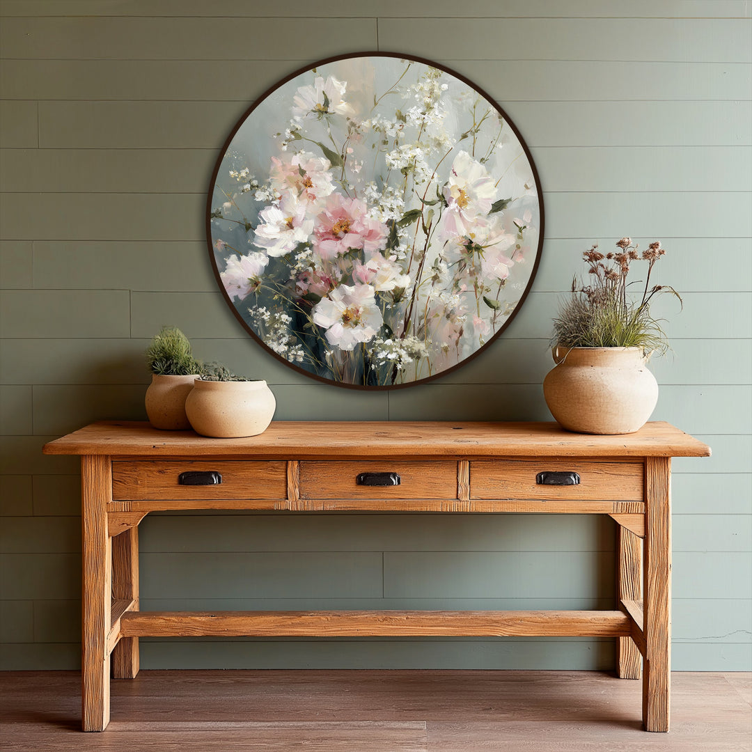 Layered, textured brushstrokes accentuate the delicate florals of this soft pastel wildflower round oil painting home decor, creating depth and visual interest.