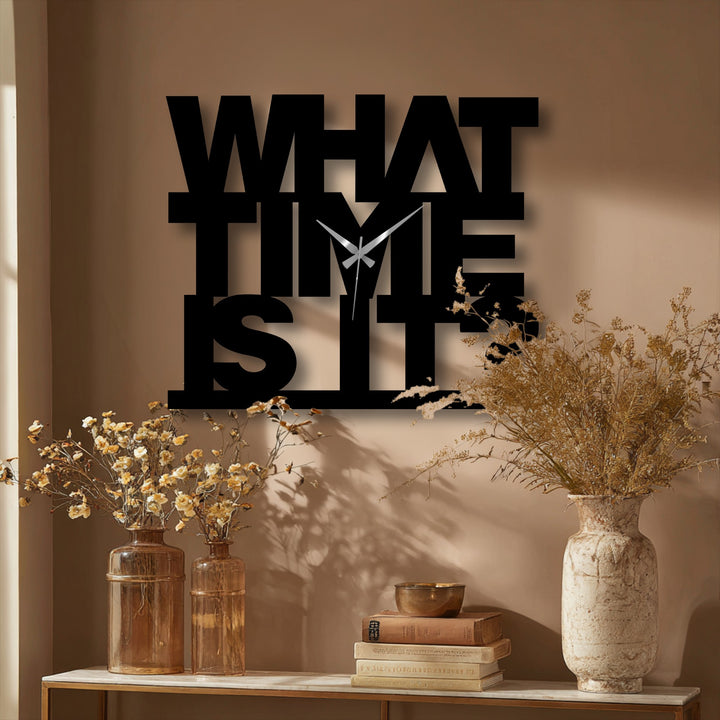 Foregrounded, the textured vases and stacked books accentuate the 'What Time Is It' metal art for wall clock's modern typography.