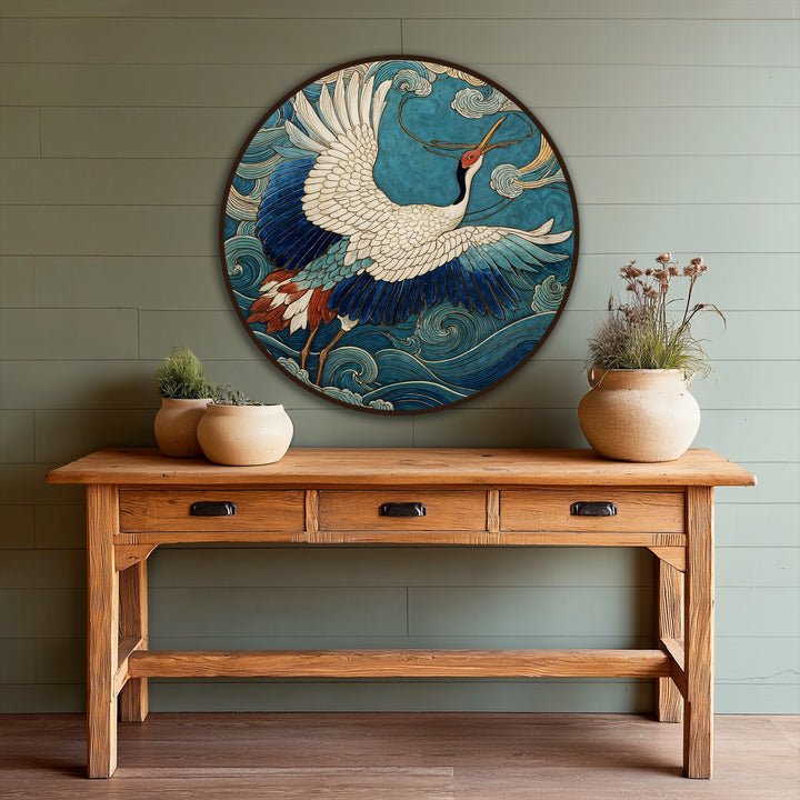 Details of the wood grain are visible on the console table beneath the 'Celestial Flight – Graceful Crane Over Ocean Waves Round Oil Painting' in oil painting decoration.