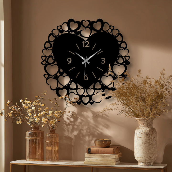 Delicate dried flowers in earthy vases softly complement the striking black heart frame metal wall decor, a romantic clock.