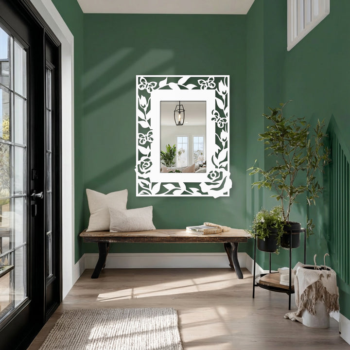 Embracing a sense of movement, the floral and butterfly frame creates a whimsical, decorative flow around this metal wall mirror, ideal for decorating with wall mirrors.