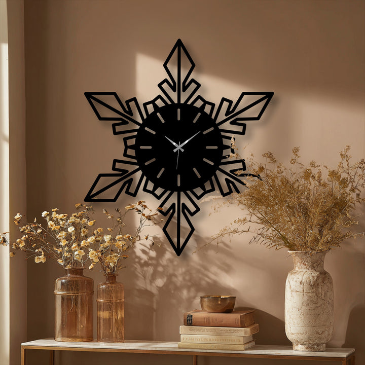 Showcasing the organic forms of a snowflake in a modern geometric metal wall clock, this decoration wall art piece features elegant points in a winter design.