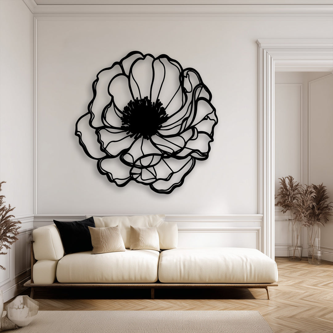 The layering effect of the unique metal wall art's minimalist black floral outline vividly contrasts against the bright white wall, adding visual depth.