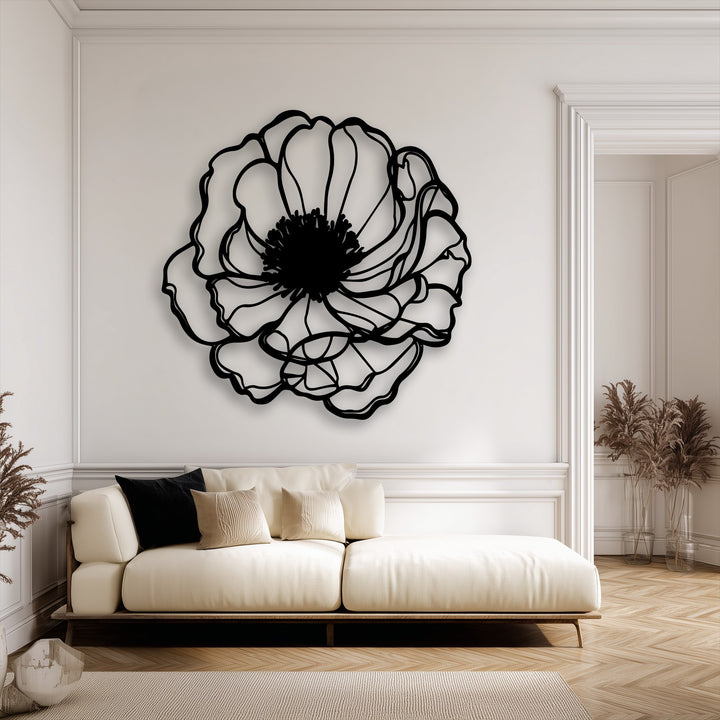 The layering effect of the unique metal wall art's minimalist black floral outline vividly contrasts against the bright white wall, adding visual depth.