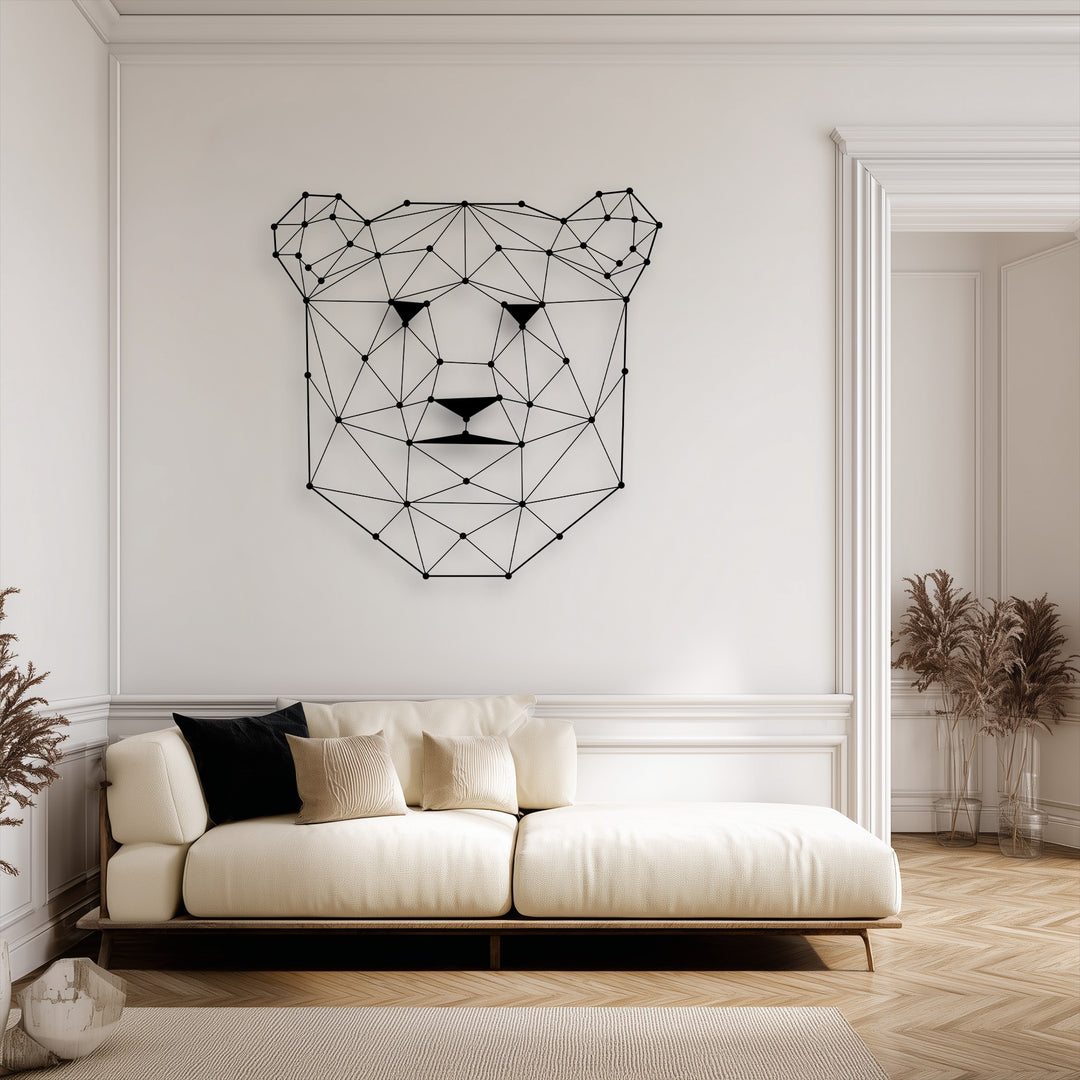 The sharp, geometric borders of the bear face metal wall decor stand out against the clean white wall, complementing the room's elegant architectural moldings.