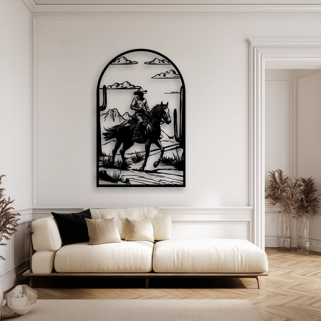 Negative space powerfully defines the black metal art for wall, featuring a cowboy on horseback traversing a rugged western desert.
